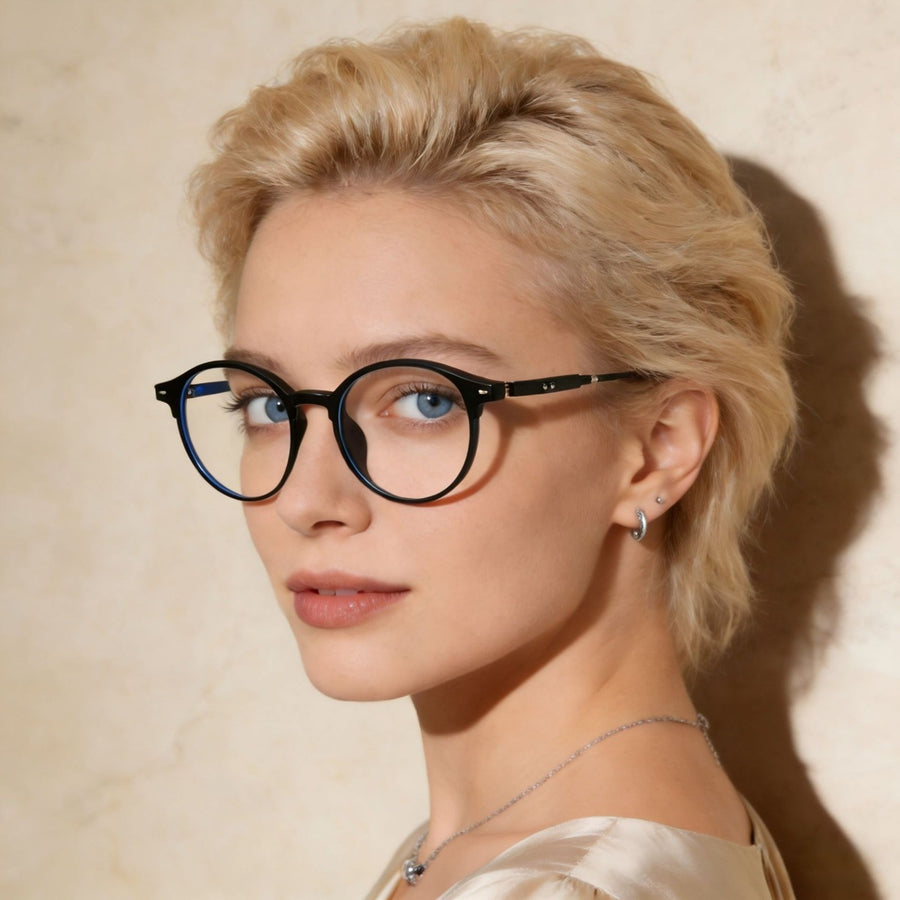 Black acetate round frame eyeglasses with clear lenses on a woman.