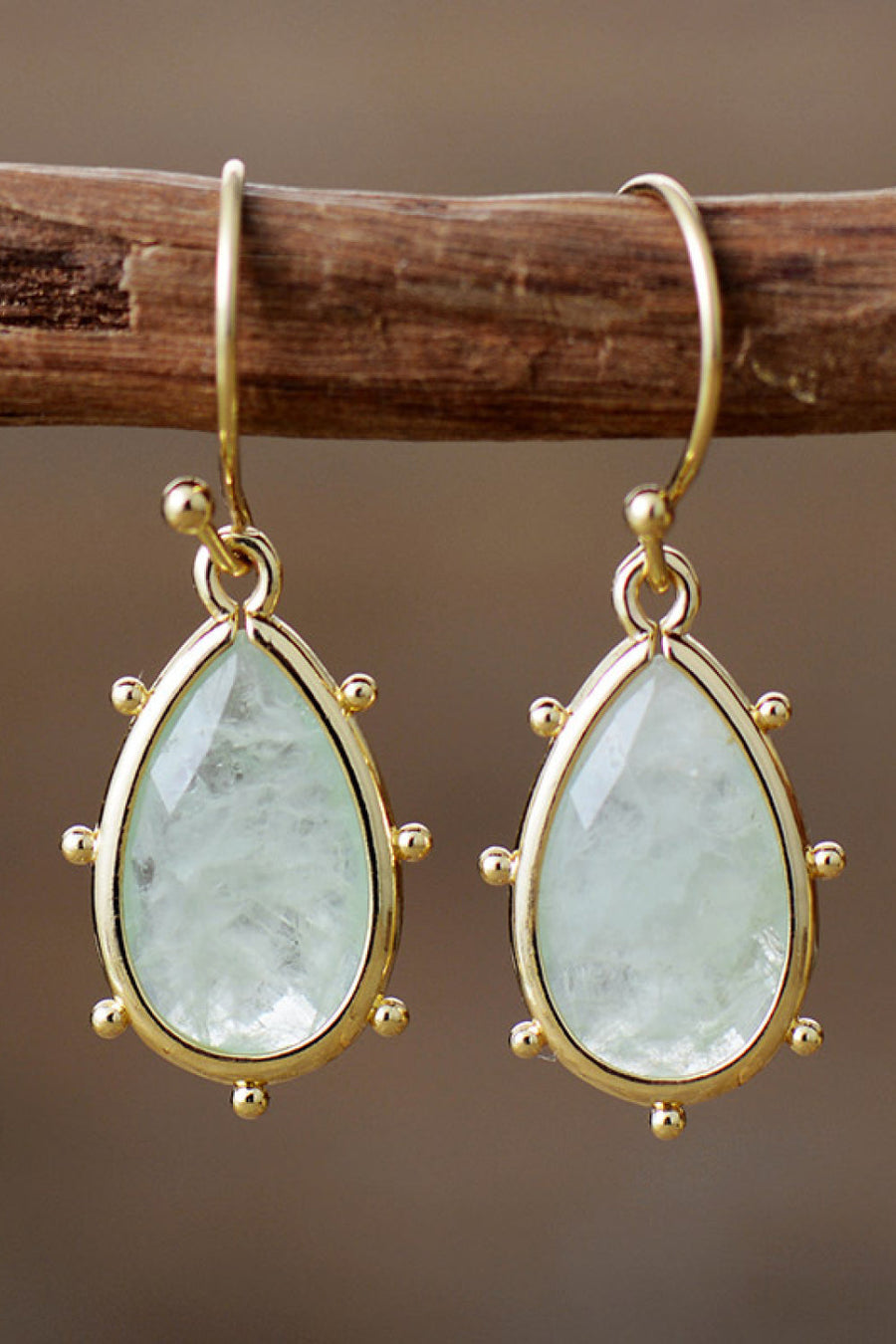 Light green teardrop amethyst earrings with gold detailing and beaded accents.