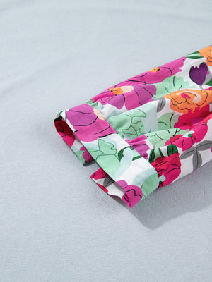 Floral V-neck midi dress with a colorful floral print and white cotton fabric.