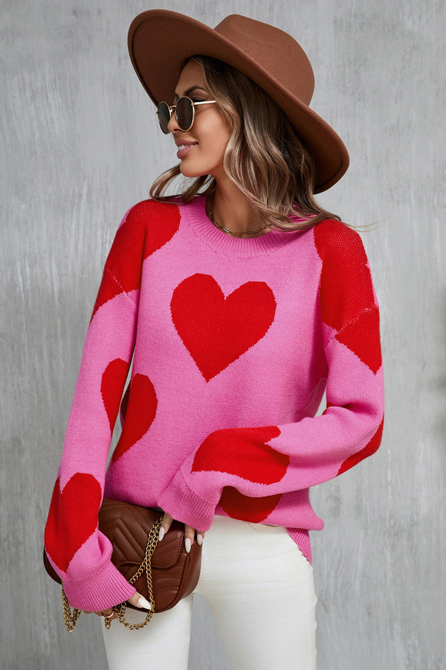 Pink acrylic knit sweater with red heart pattern, crew neck, long sleeves.
