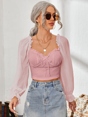Pink bustier blouse with tie front and sheer puff sleeves