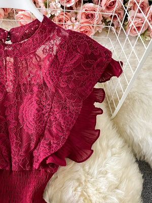 Red lace maxi dress with ruffled sleeves and high neckline.