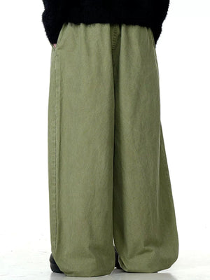 Relaxed wide-leg trousers in Army Green with drawstring waist and pockets.