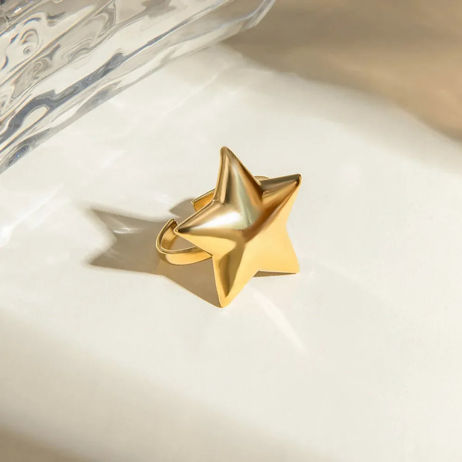 Gold starburst adjustable ring with a bold, sculpted design.