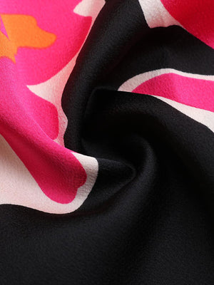 Vibrant floral midi dress in black with pink and orange abstract flower print.