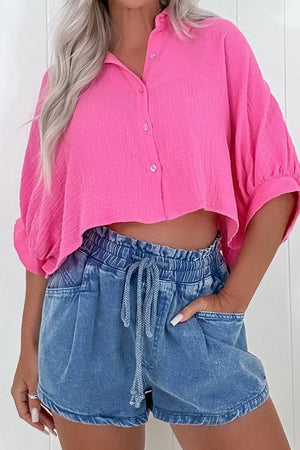 Paperbag waist denim shorts in medium wash with drawstring and relaxed fit.