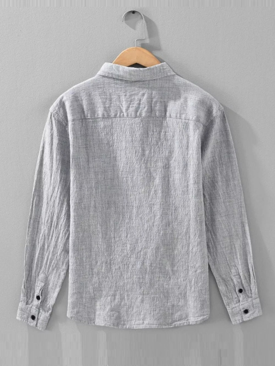 Grey linen textured long sleeve button-up shirt with button cuffs.