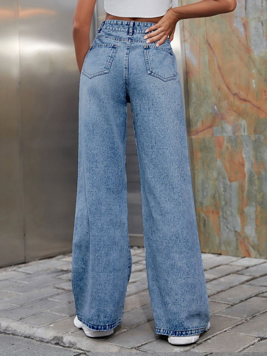 Light wash distressed flare jeans with a wide leg fit.