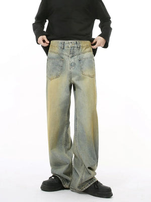 Distressed denim jeans in a medium wash with a relaxed fit and vintage fade.