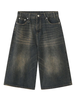 Wide-leg distressed denim culottes in dark wash with button fly and frayed hem.