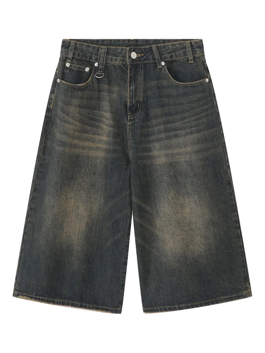 Wide-leg distressed denim culottes in dark wash with button fly and frayed hem.