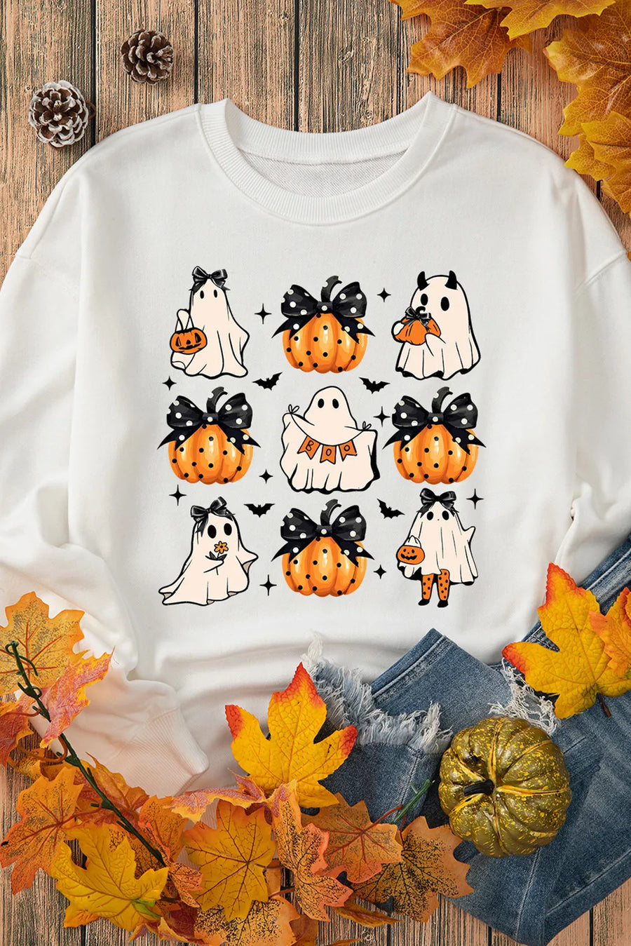 White graphic sweatshirt with a patchwork of cute ghosts and pumpkins, perfect for autumn.