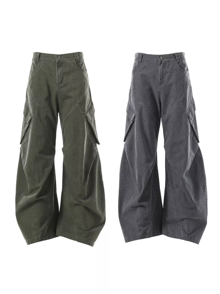 Textured paneled cargo pants in army green and dark gray with baggy fit and large pockets.