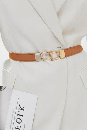 Caramel belt with linked rectangle buckle and gold hardware, worn over a white blazer.