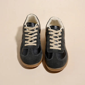Black suede and leather retro trainers with beige laces and gum soles.