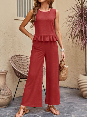 Red ruffled hem sleeveless top and wide-leg pants set with textured fabric.