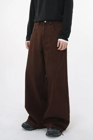 Wide-leg brown denim jeans with sculpted volume and a relaxed fit.