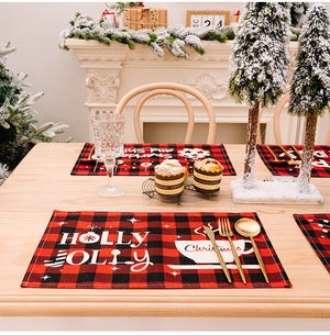 Festive plaid placemat with Holly Jolly text and Christmas cup design, red and black.