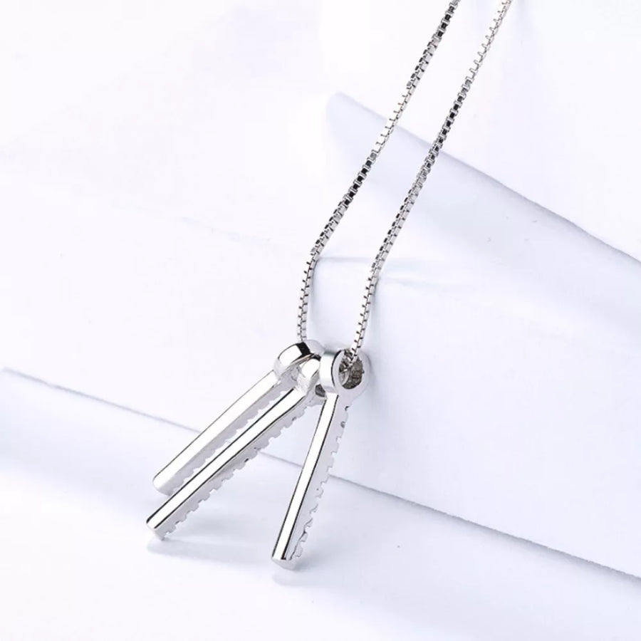clear necklace featuring tassel pendant and geometric