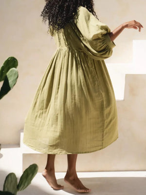 Matcha tie-neck midi dress with puff sleeves and a gathered skirt.