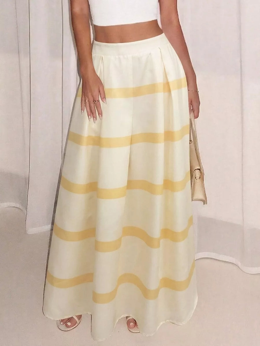 Flowy maxi skirt with yellow stripes and pockets, pleated waist, white crop top.