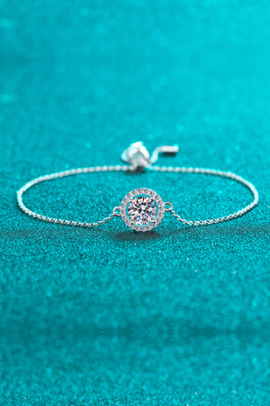 Silver adjustable bracelet with a round halo moissanite center stone.