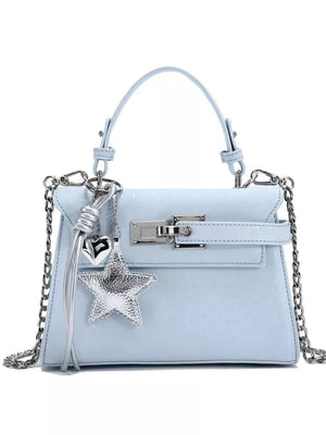 Light blue embossed mini handbag with silver star and heart charms and chain strap.