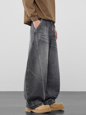 Men's baggy dark wash vintage jeans with cinched hems and cotton fabric.