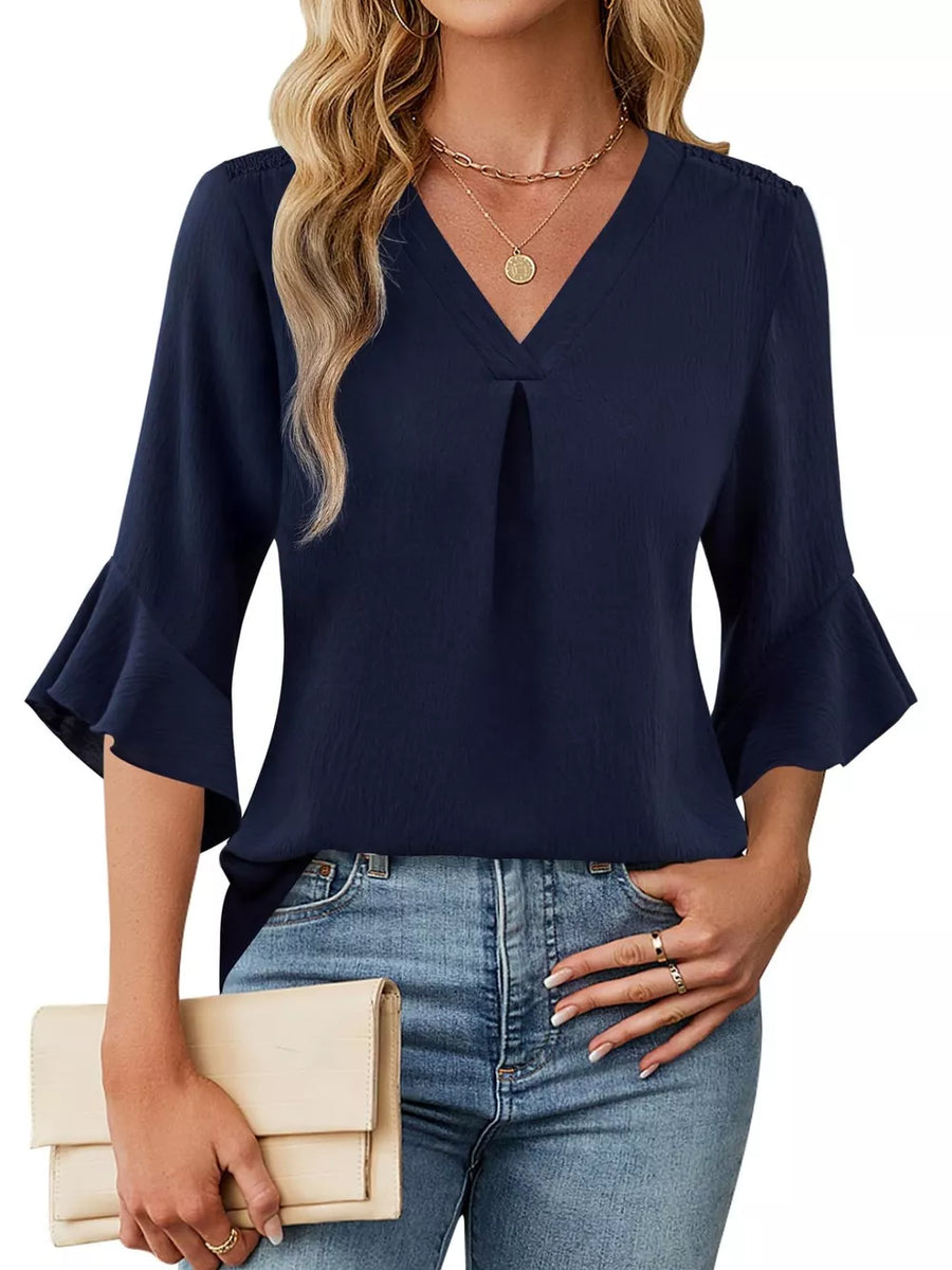 Navy V-neck blouse with ruffle sleeves and a subtle textured fabric.