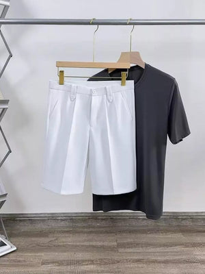 White pleated chino shorts with pockets, shown with a dark gray t-shirt.