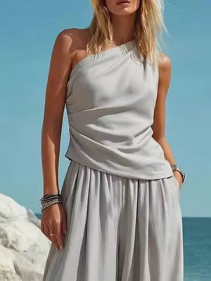 Gray one-shoulder top and wide-leg pants set with draped detail and pockets