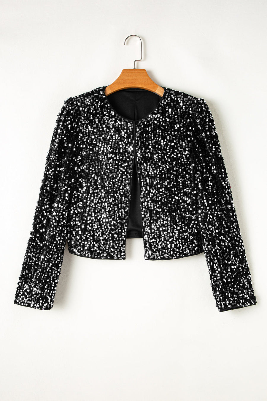 Black sequin embellished cropped open jacket with round neckline and long sleeves.