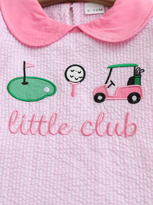 Pink and white seersucker baby dress with golf embroidery and a Peter Pan collar.