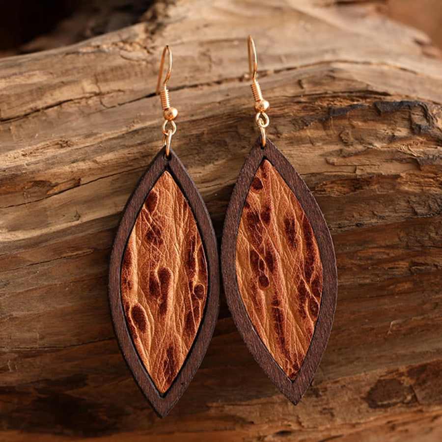 Tooled leather and wood drop earrings with a marquise shape and natural texture.