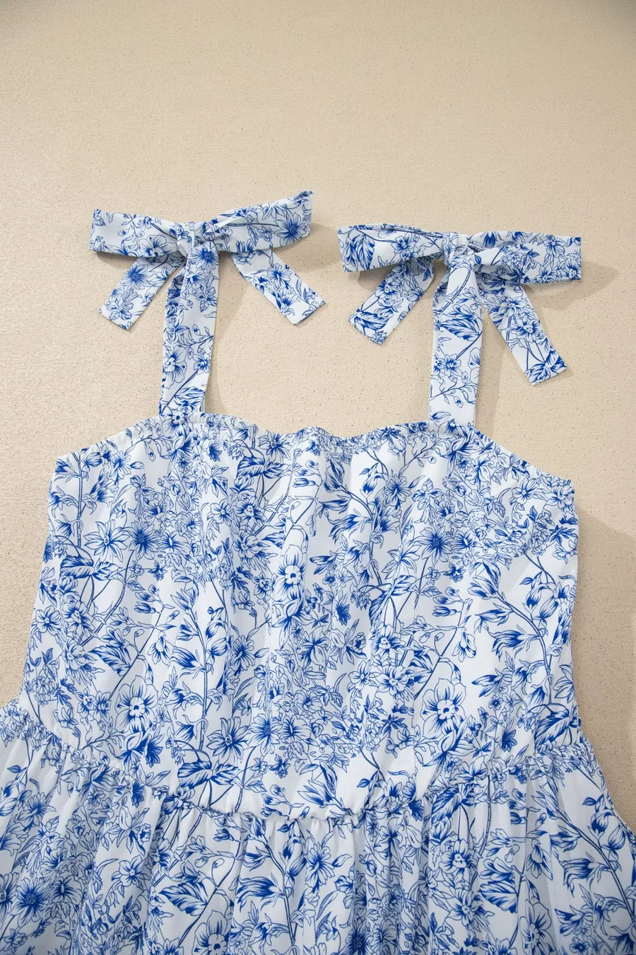 Maxi dress with blue floral print and tie shoulder straps