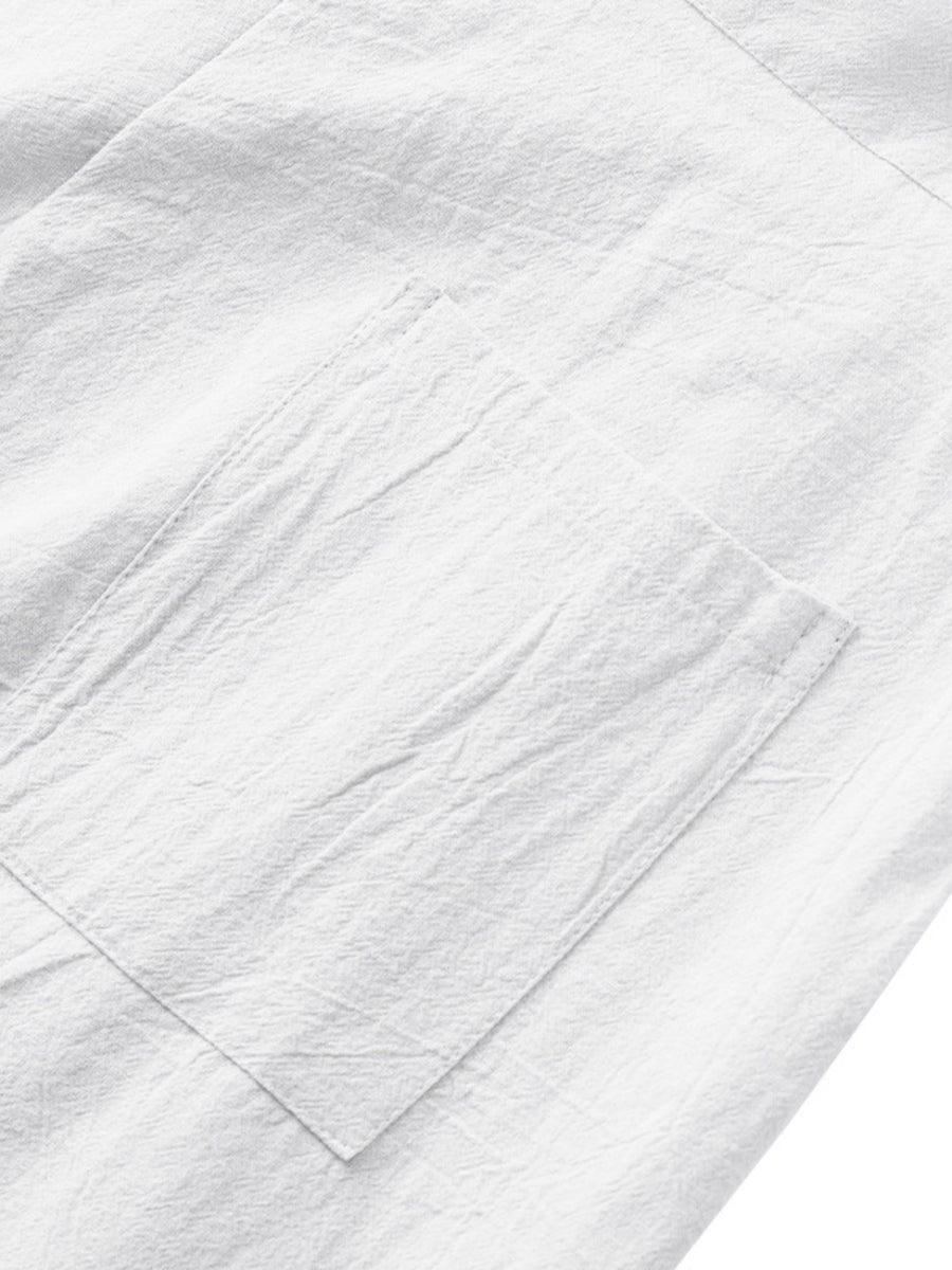 White sweatpants with a textured fabric and a single patch pocket detail.