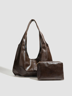 handbag in dark brown featuring matching pouch and relaxed fit