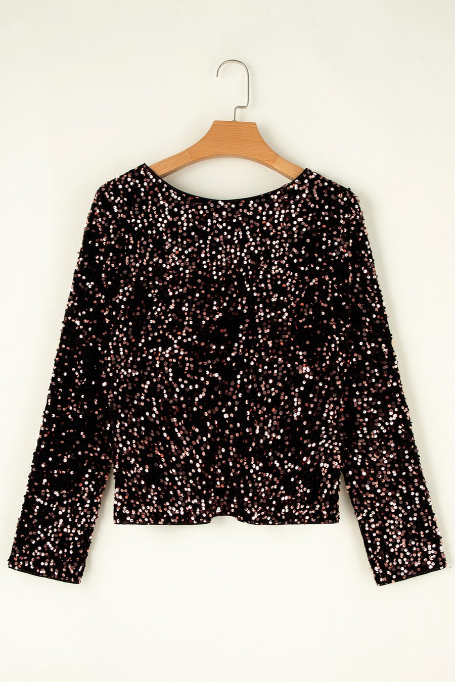 Black sequin backless blouse with long sleeves and a round neckline.