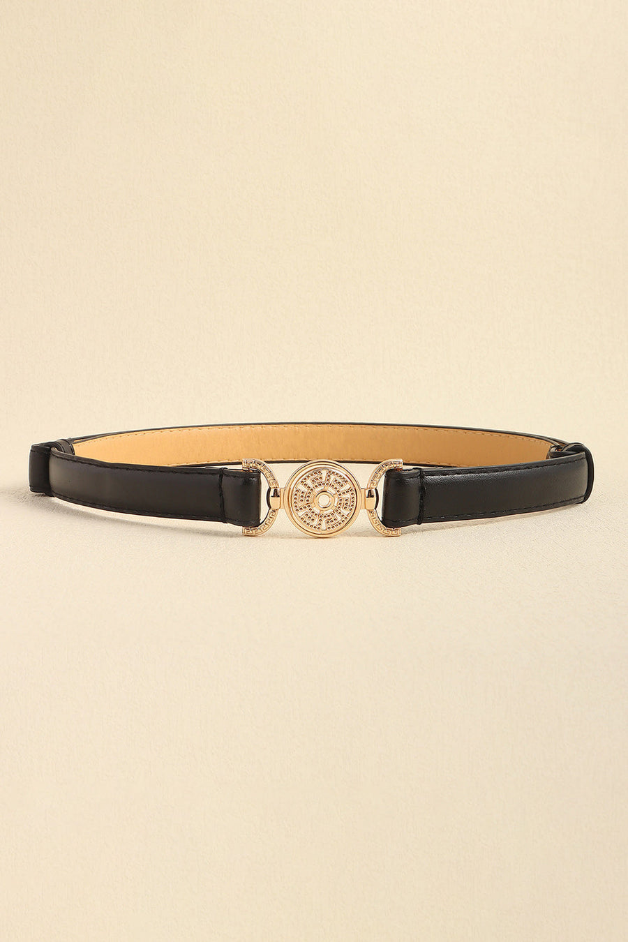 Black leather belt with crystal-embellished gold circular buckle and side details.