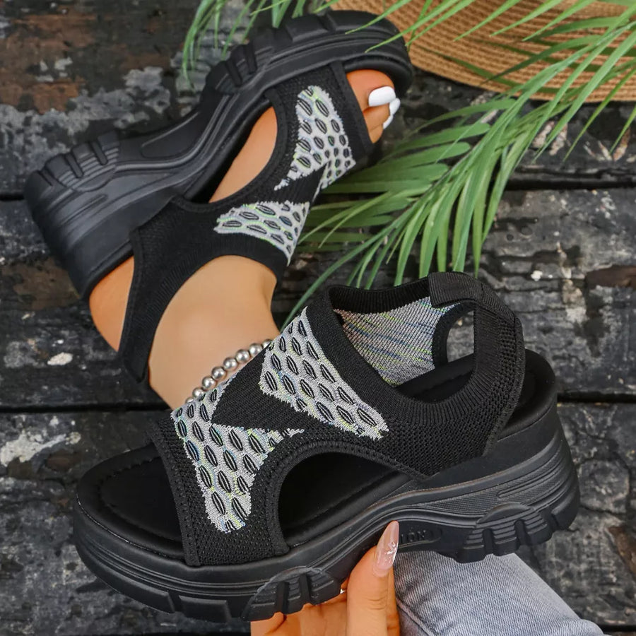 Black open-toe platform sandals with geometric pattern knit fabric and chunky sole.