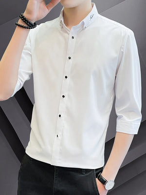White cotton button-down shirt with black buttons and 3/4 sleeves.