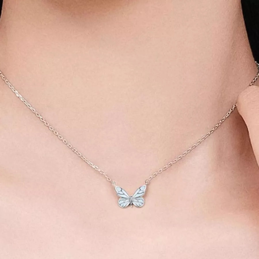 light blue necklace featuring butterfly pendant and motif