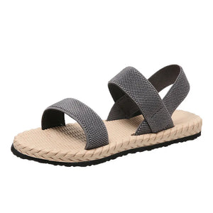 Gray rope-sole cross-strap sandals with adjustable elastic straps and textured footbed.