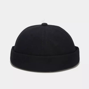 hat in black featuring brimless and fitted fit