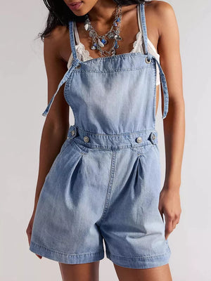 medium wash denim overalls with thigh-length and button