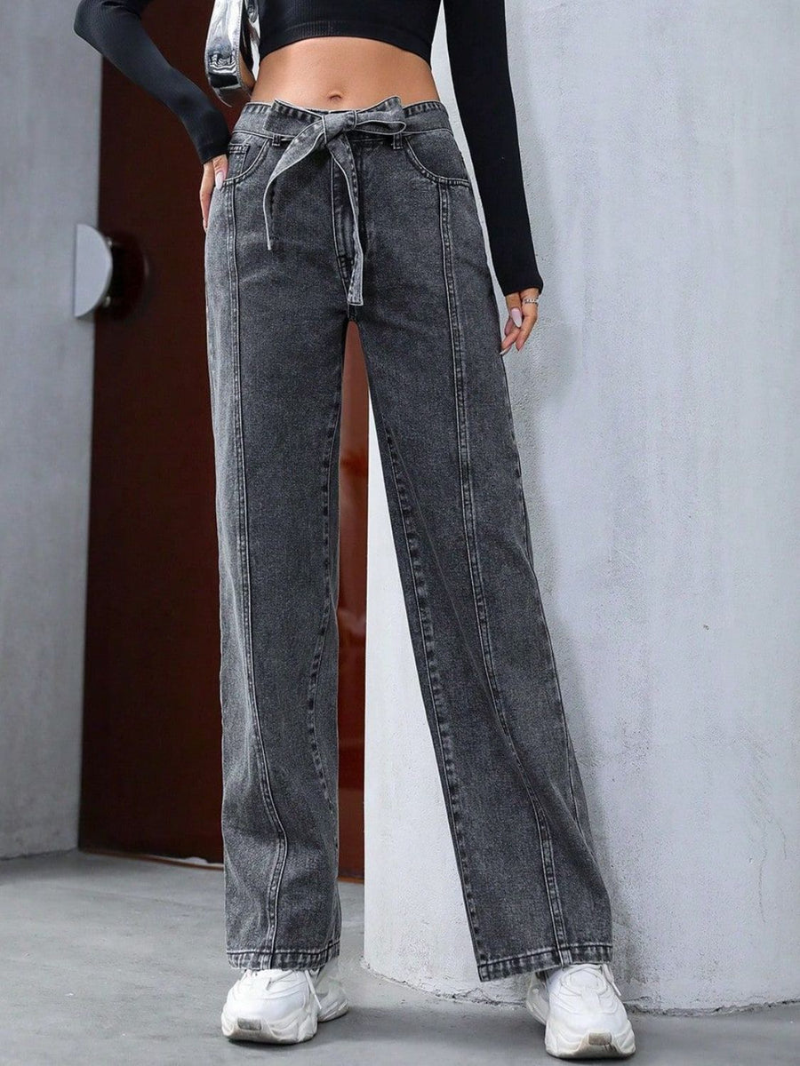 Belted wide-leg washed denim trousers in dark gray with a tie waist and seam detail.