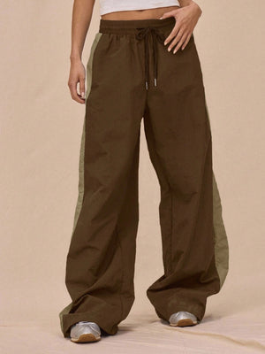 sage green tracksuit featuring drawstring waist and color-block