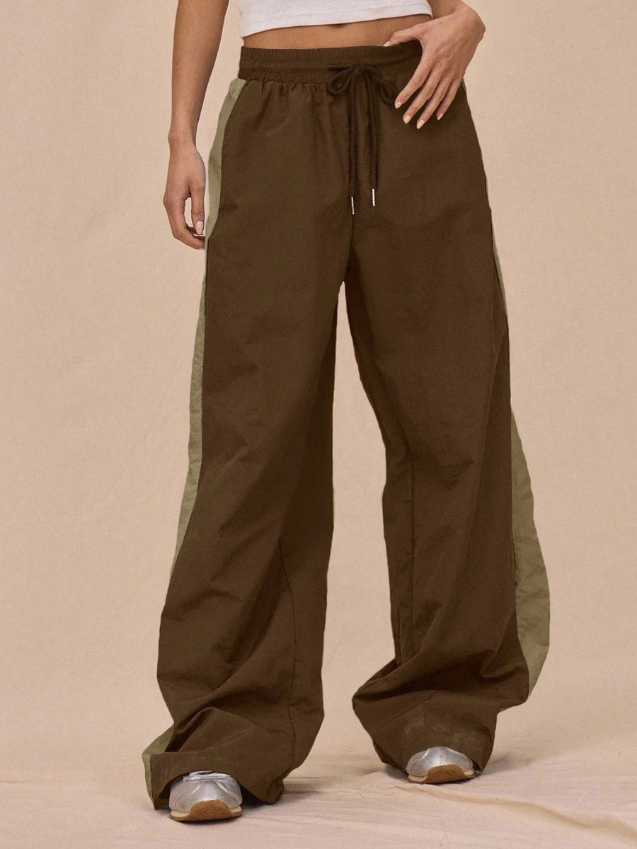 sage green tracksuit featuring drawstring waist and color-block