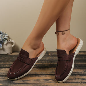 Brown textured round toe slip-on loafers with a backless design and white sole.