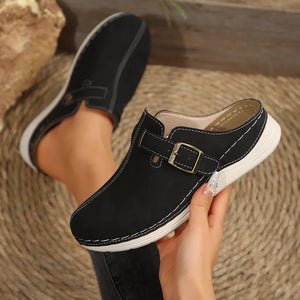 Black buckle accent round-toe slip-on flats with contrast stitching.